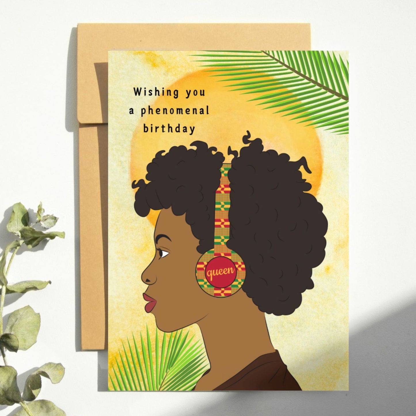 Phenomenal birthday greeting card featuring a black woman with kente print headphones on